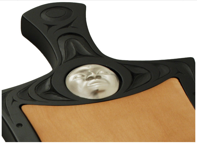 Cheese board with Indigenous motif design and pewter moon mask