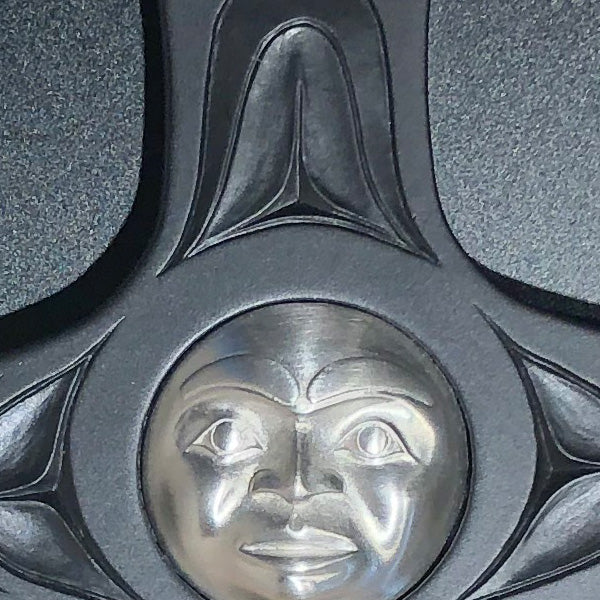 Cheese board with Indigenous motif design and pewter moon mask
