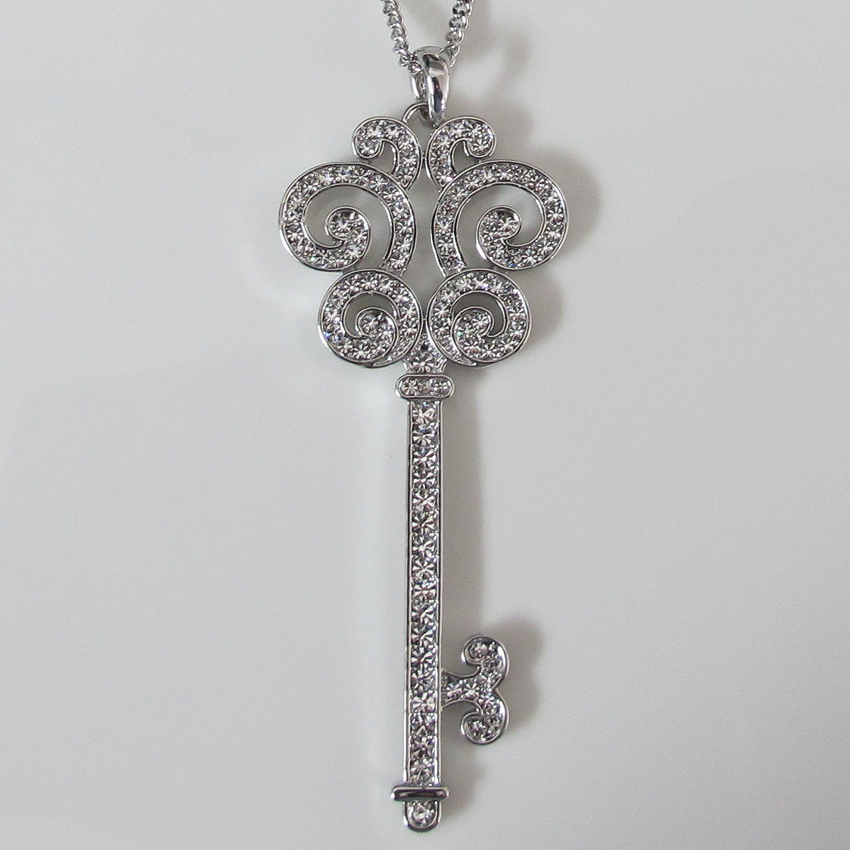 Glimmering key pendant long necklace