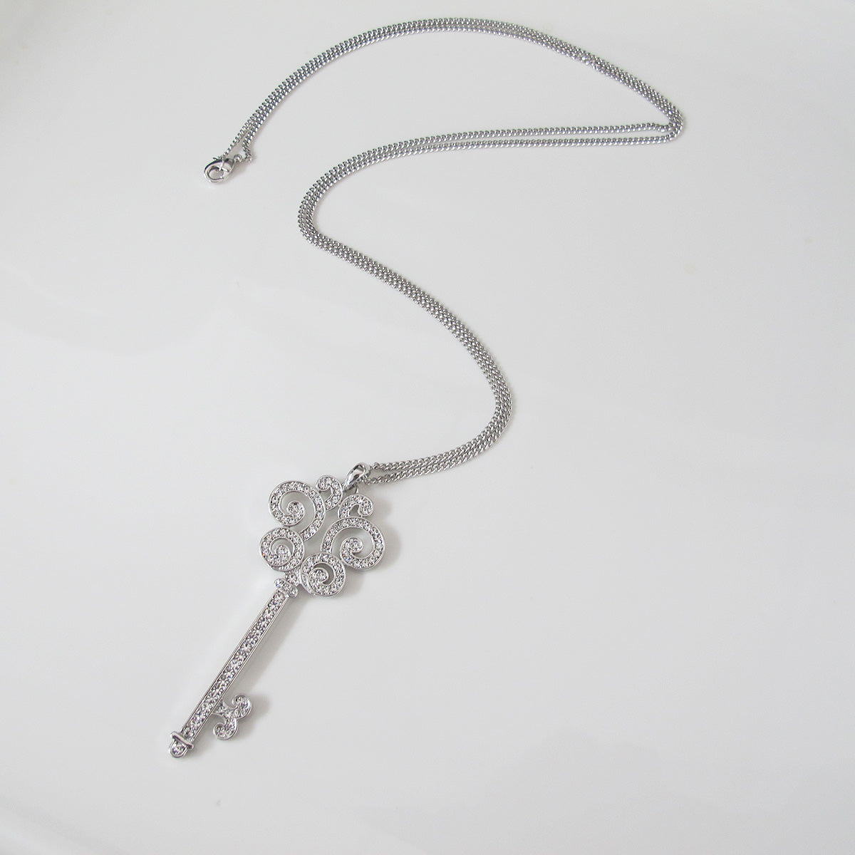 Glimmering key pendant long necklace