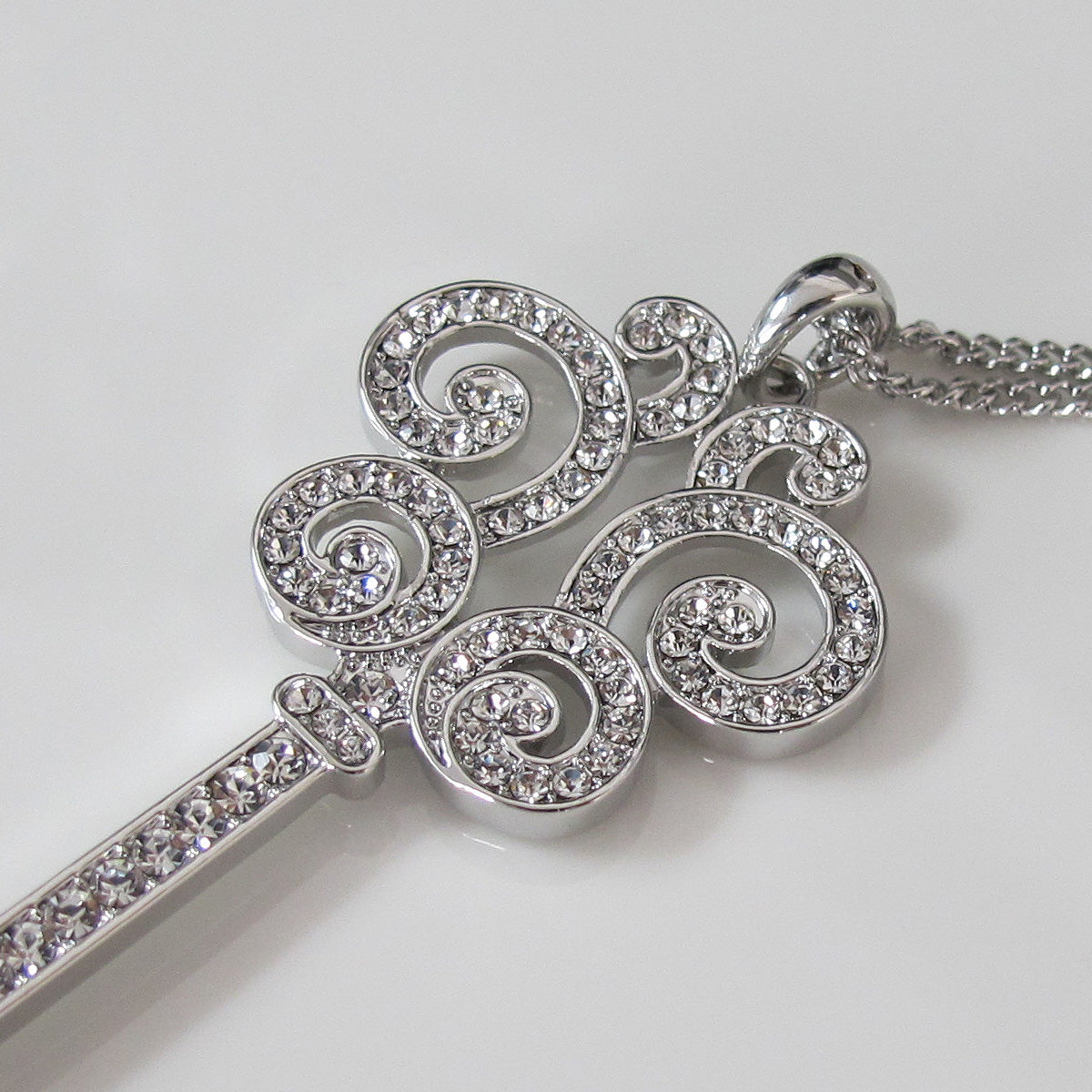 Glimmering key pendant long necklace